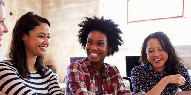 Group Of Female Designers Having Meeting In Modern Office